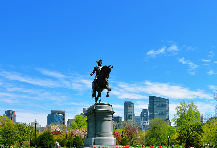 A panoramic view of the Public Garden in Boston, Massachusetts, featuring the iconic equestrian statue of George Washington.